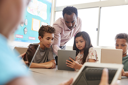Teacher helping kids in classroom