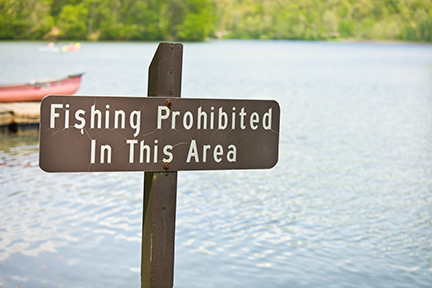 A "Fishing Prohibited In This Area" sign on a lake