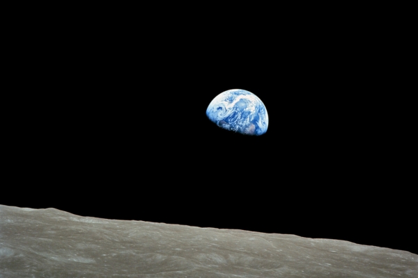 photo of our Earth rising above the surface of the moon