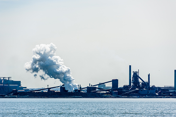 Steam plume released at steel factory near water in Hamilton, Ontario, Canada