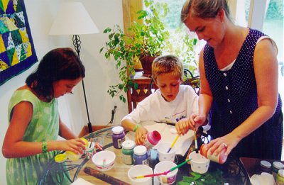 Mom and kids pouring paint Mom and kids pouring paint
