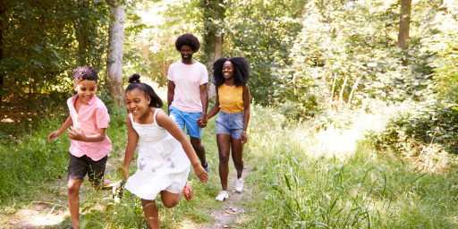 photo of kids and grownups hiking in the woods